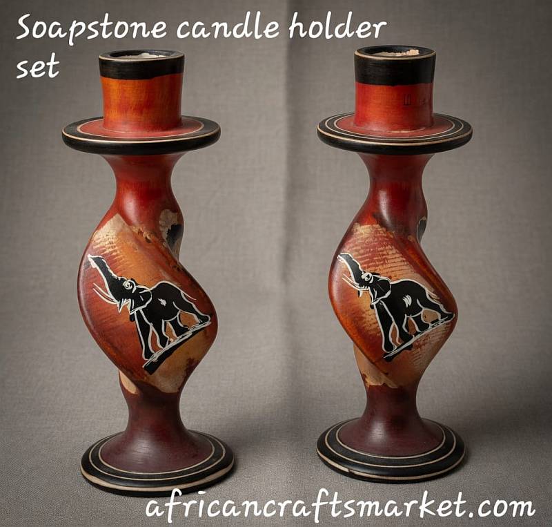 Pair of African stone candle holders hand-carved with a sleek spiral twist pillar and etched black elephant designs