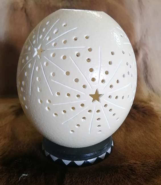 Carved ostrich egg - Stars and candle Carved ostrich egg - Stars and candle