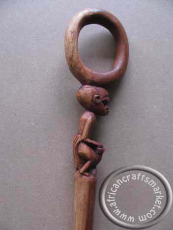 African sitting man cane-close up