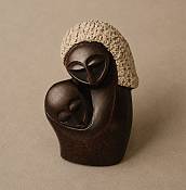 bstract African Stone Mother and Child Sculpture Minimalist African soapstone carving showing an abstract silhouette of a mother and child in a continuous, flowing embrace