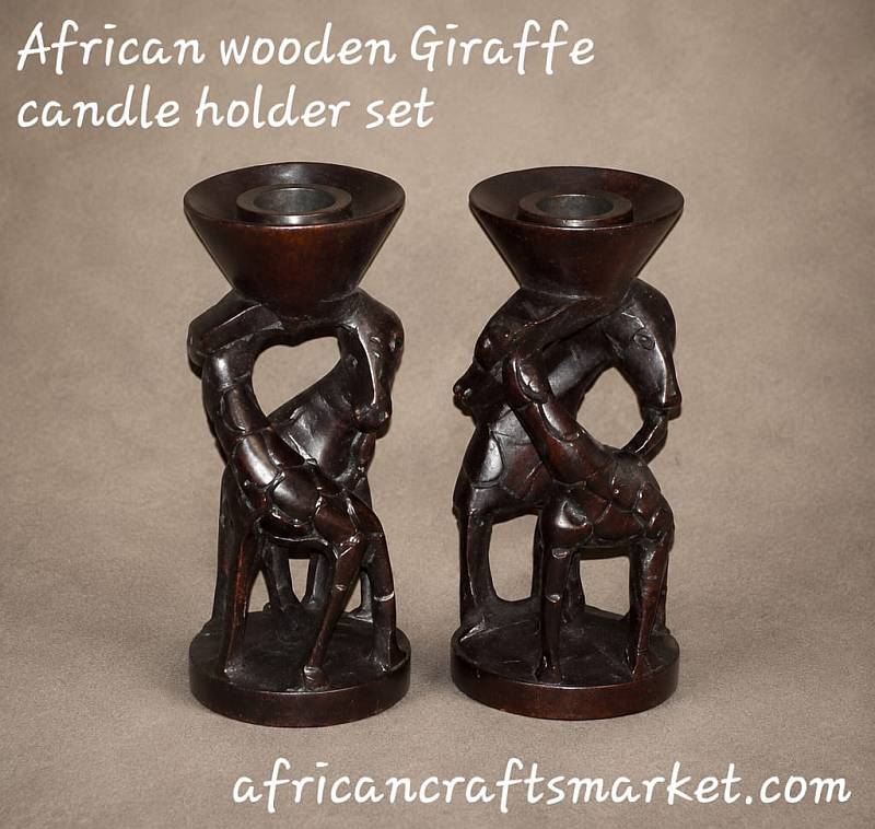 Pair of tall hand-carved African wooden candle holders sculpted as elegant giraffes with detailed hand-painted spots