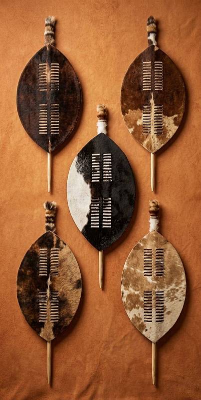 Authentic Zulu Dancing Shields - Assorted Cattle Hide Patterns Collection of authentic Zulu dancing shields in various Nguni cattle hide patterns including brown, white, and black