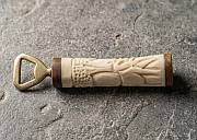 A collection of handcrafted African bone bottle openers showing unique batik geometric patterns and polished cow bone handles