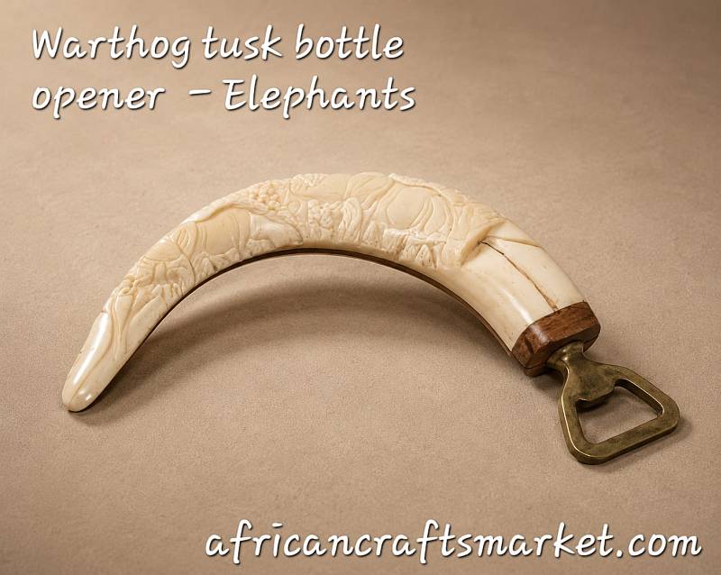 A genuine African warthog tusk bottle opener featuring an intricate, hand-carved 3D relief sculpture of a majestic African elephant along the polished ivory handle.