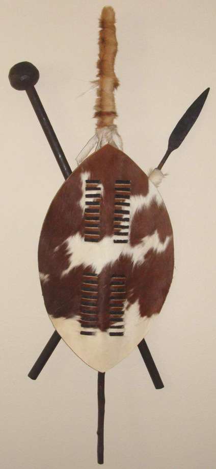 A 75cm Zulu cowhide shield mounted as African tribal wall art
